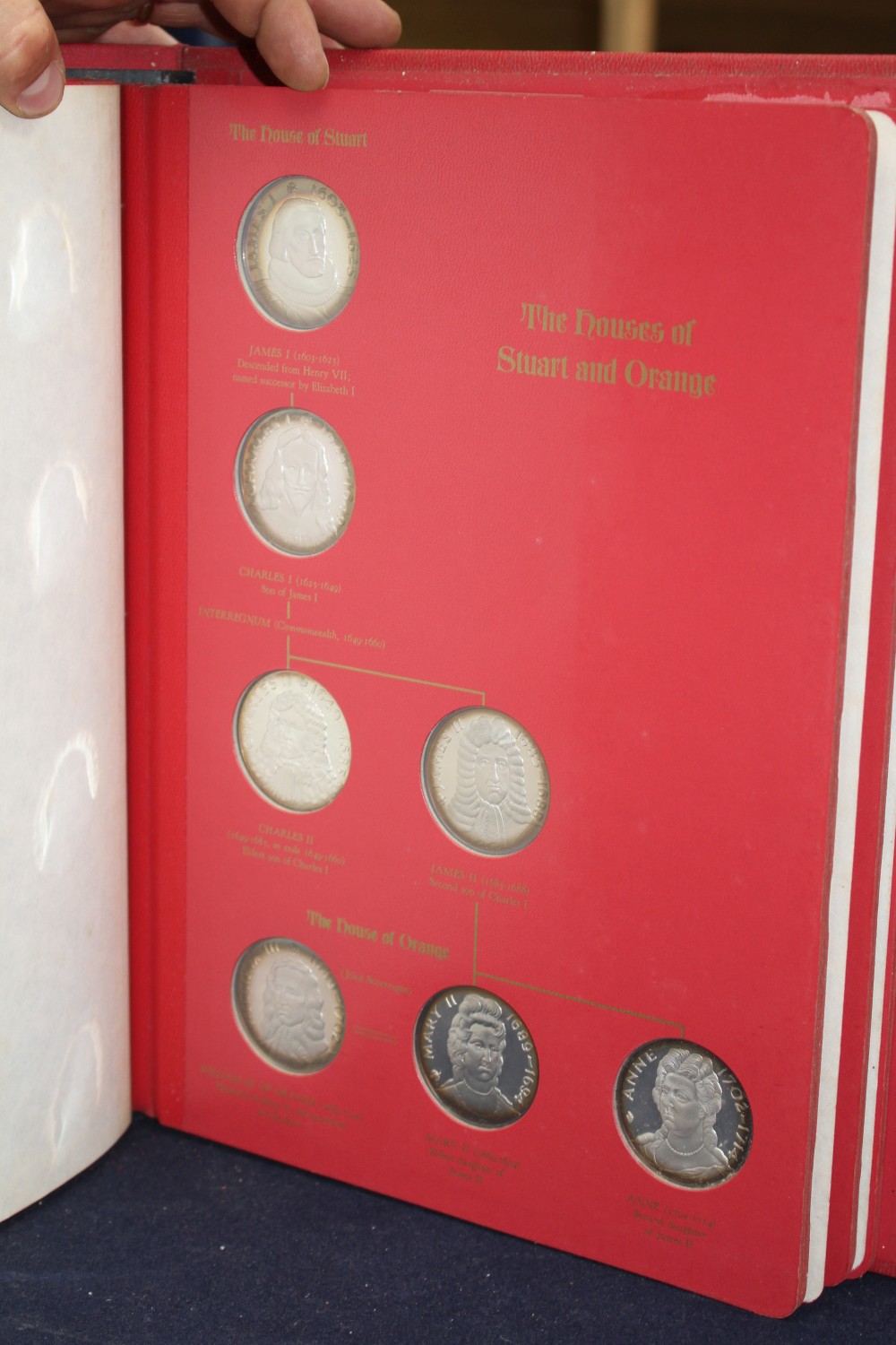 A set of the Kings and Queens of England sterling silver proof medallions, housed in original album and three other cased sets